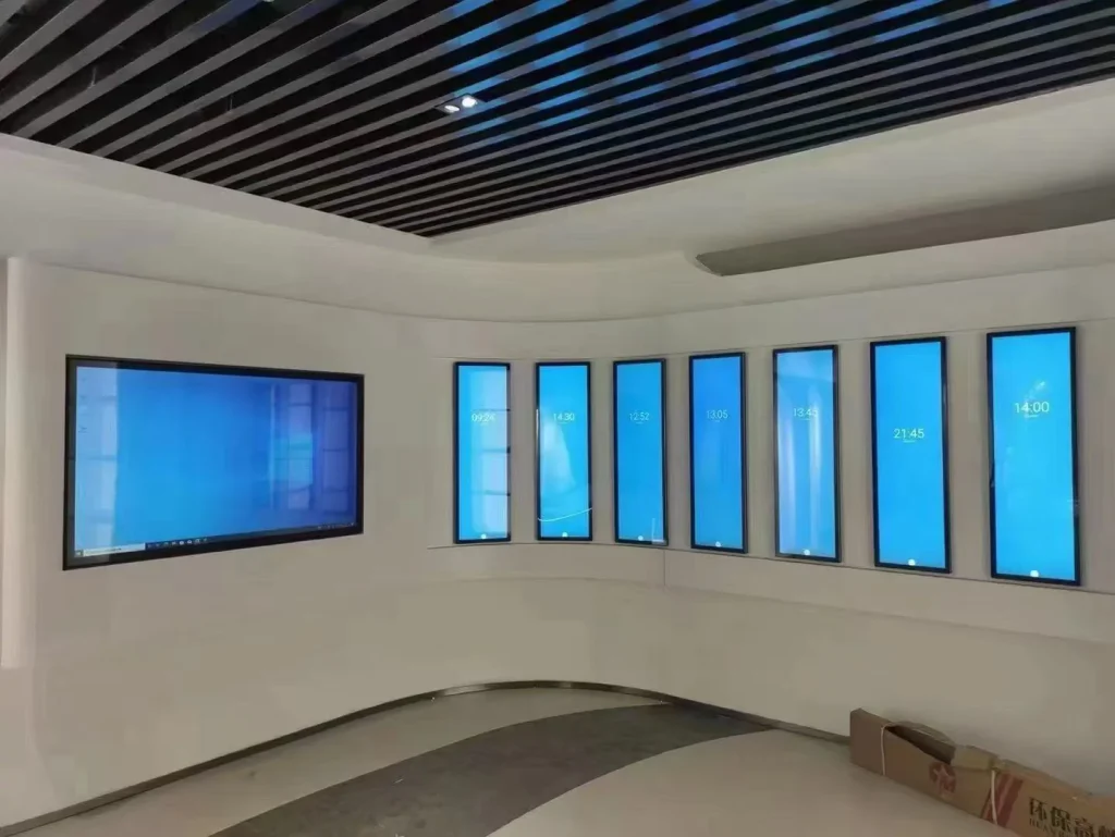 Embedded combination of horizontal LCD display and vertical stretched bar digital signage on curved showroom wall