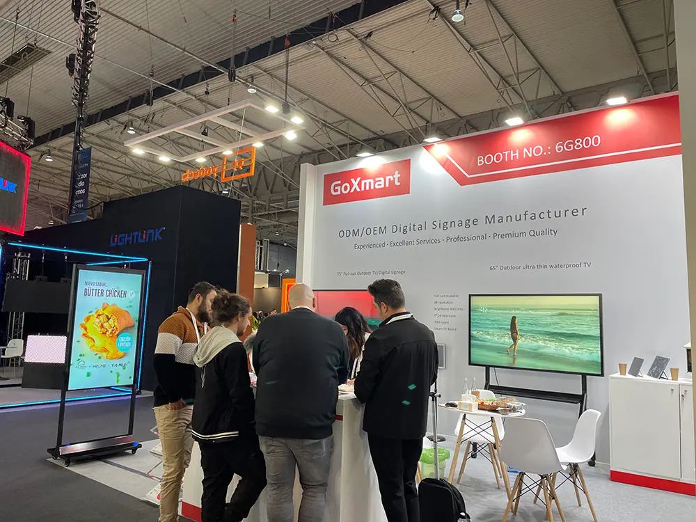GoXmart booth at ISE exhibition, clients consulting digital signage products at trade show