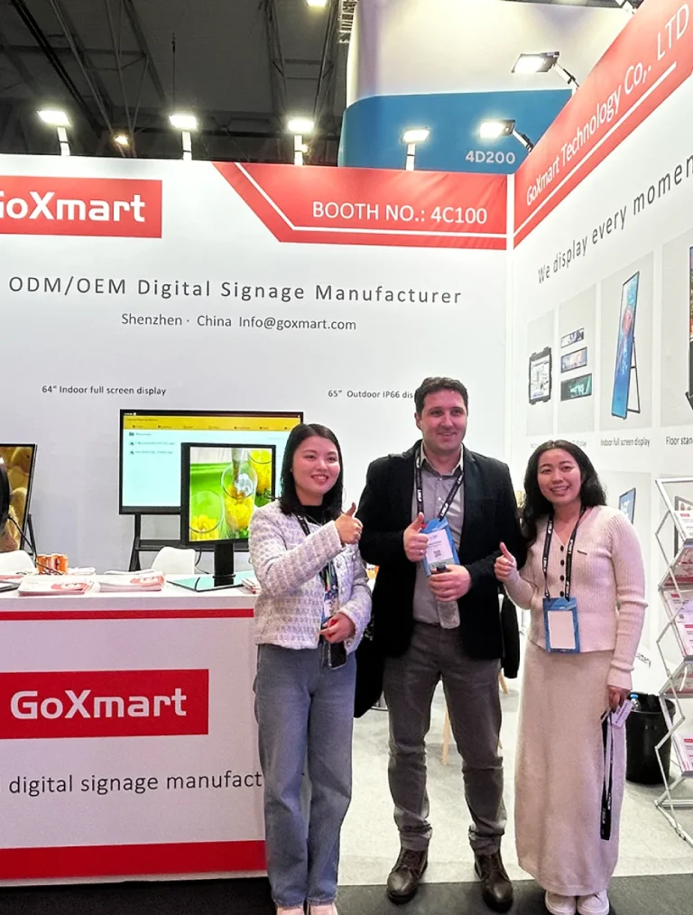 goxmart team taking thumbs‑up group photo with buyers at ISE exhibitiongox
