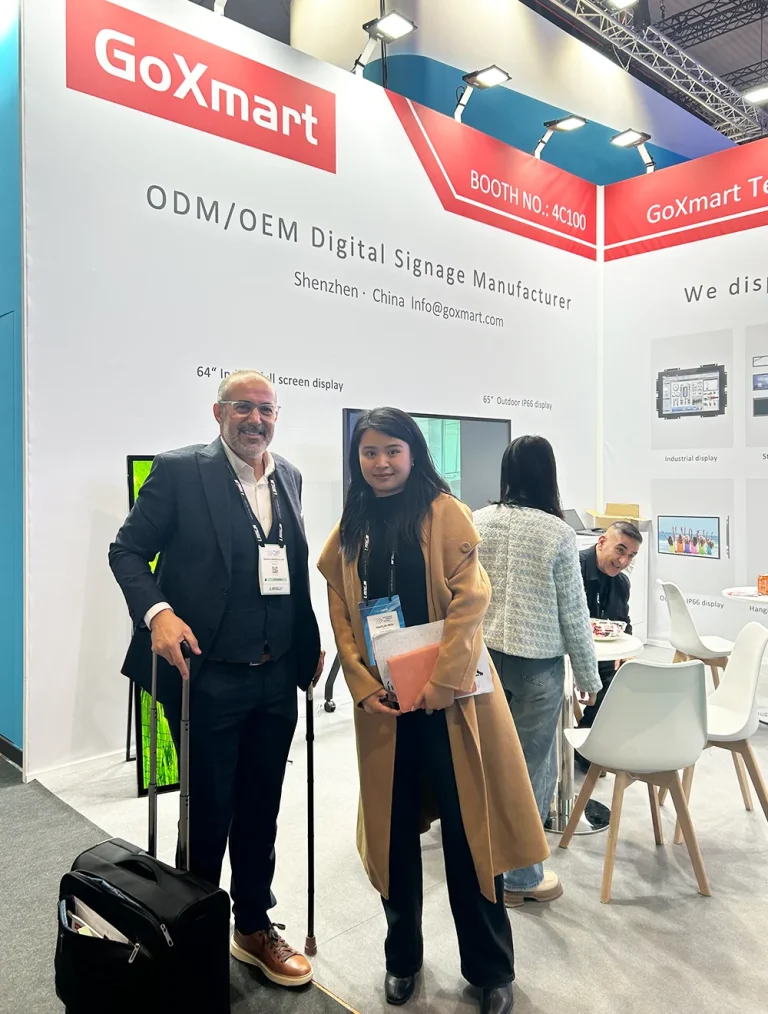 goxmart sales member taking photo with business buyer at ISE trade show booth