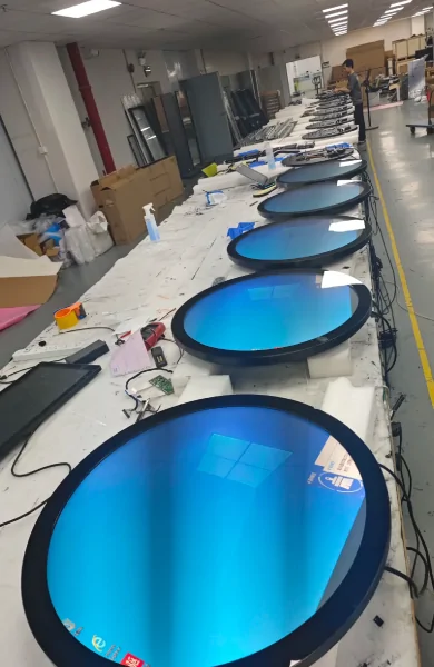 goxmart production line, multiple circular round lcd digital signage displays being assembled and tested