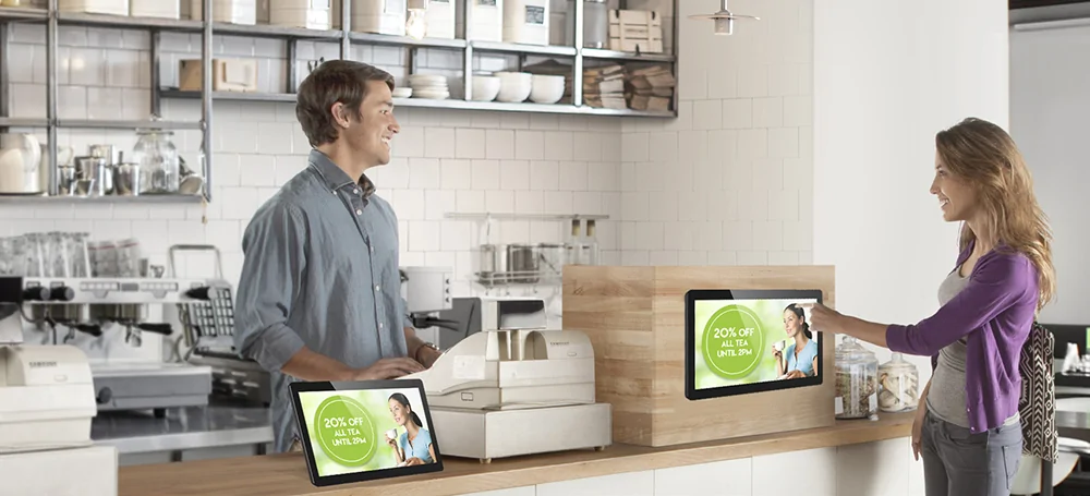 Point of sale digital signage screens showing discount promotion at retail checkout counter