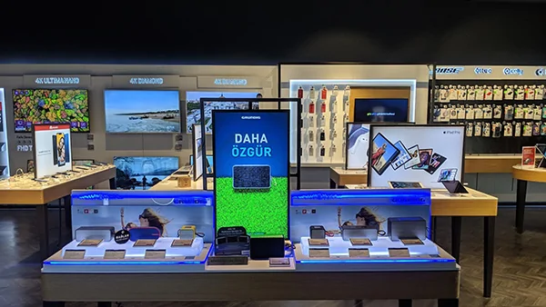 Retail demo booth with multiple digital signage screens at InfoComm exhibition, AVIXA digital display showcase