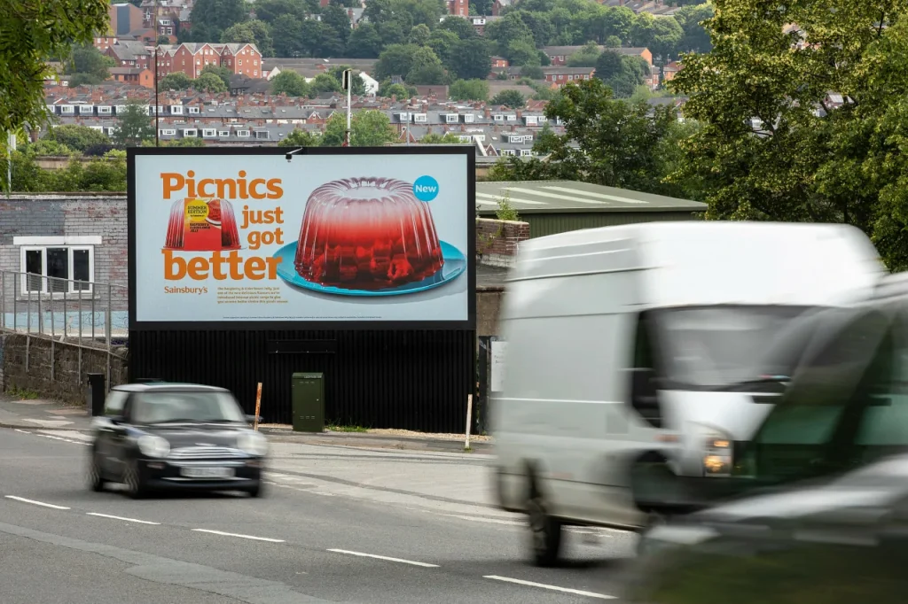 Roadside DOOH digital billboard advertising screen beside highway for retail brand outdoor marketing