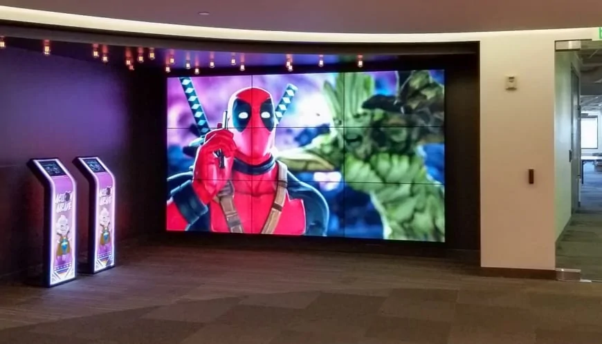Large indoor video wall digital signage paired with vertical self-service kiosks for commercial entertainment display